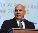 Dr. Anand Rao speaking at a podium